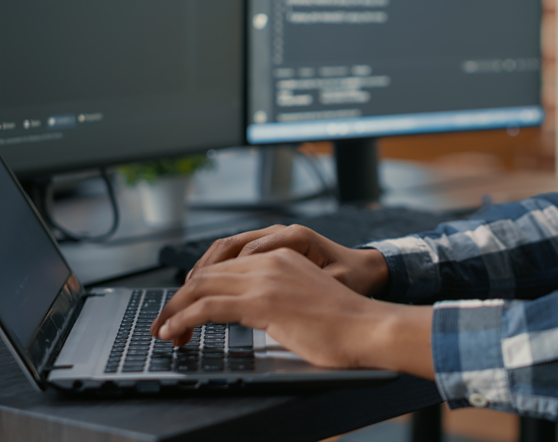man typing on keyboard